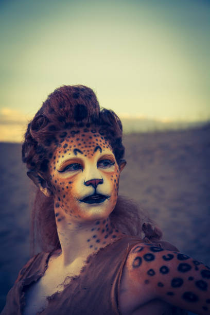istock Model Wearing Cheetah Makeup Posing The Desert 647494284