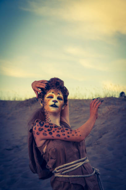 istock Model Wearing Cheetah Makeup Posing The Desert 647494286