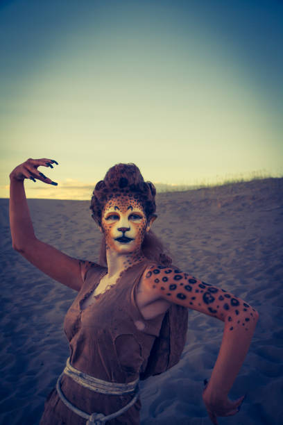 istock Model Wearing Cheetah Makeup Posing The Desert 647494322