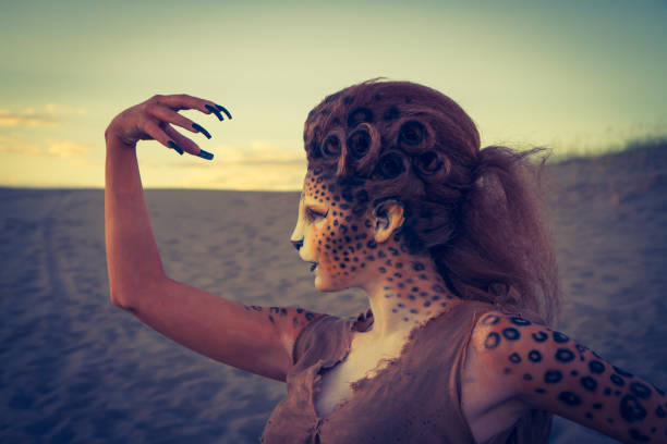 istock Model Wearing Cheetah Makeup Posing The Desert 647494356