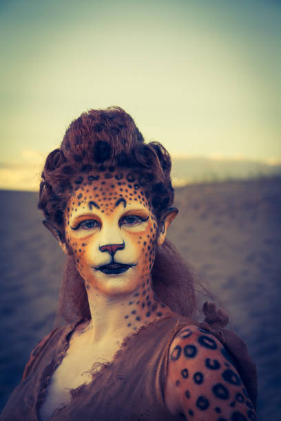 istock Model Wearing Cheetah Makeup Posing The Desert 647494358