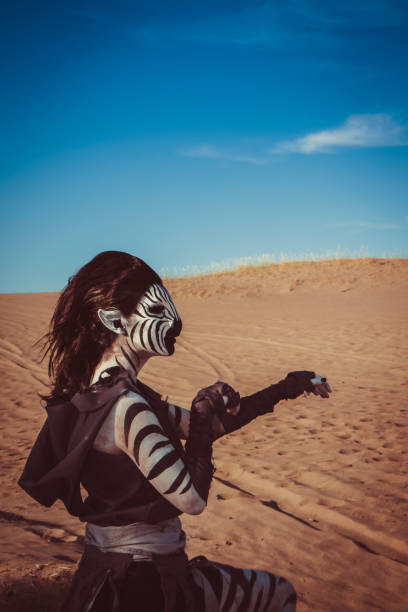 Model Wearing Zebra Makeup Posing The Desert Model Wearing Zebra Makeup Posing The Desert. A young woman wears Anthropomorphic makeup and poses creatively in the desert. 7676 stock pictures, royalty-free photos & images