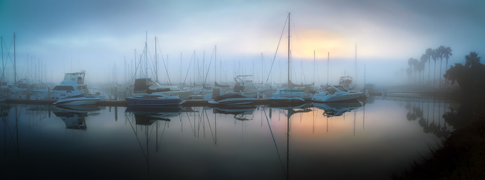 yachts on the pier in the fog