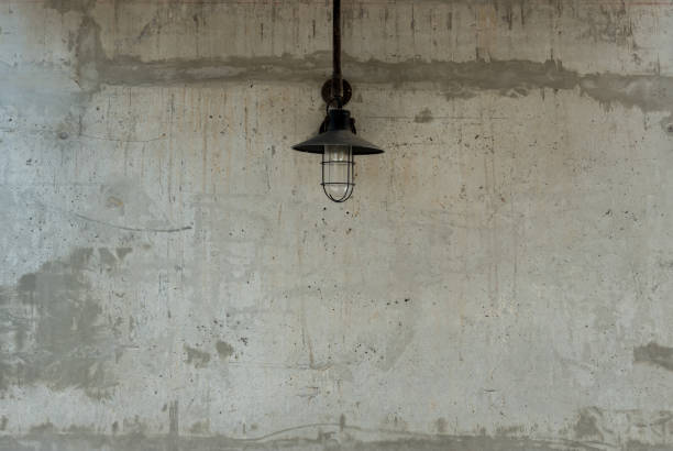 istock Raw concrete texture with old lamp useful as a background. 647507666
