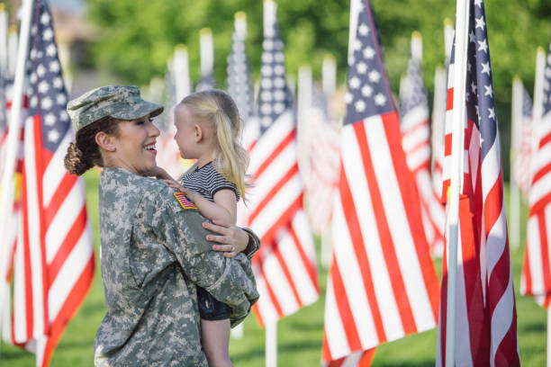 American female soldier with 3 year old girl stock photo