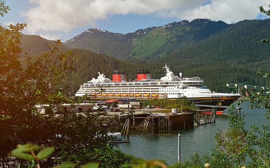 Cruise ship in Alaska port on day. Tourism on cruise line to alaska mountain