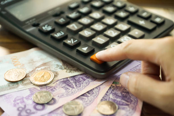 istock Hand with a calculator and thai baht Money 647537748