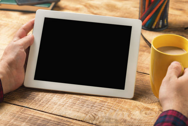 istock Close up white tablet with copy space in male hands 647537880