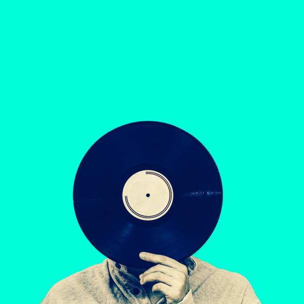 istock man holding record, isolated on green. art filter, music background 647541110