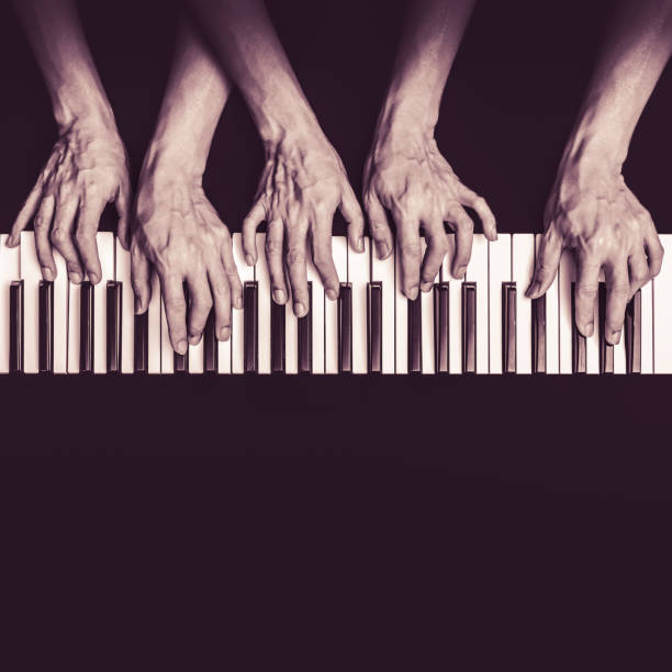istock five hands playing on piano keys, black and white. music background 647545102