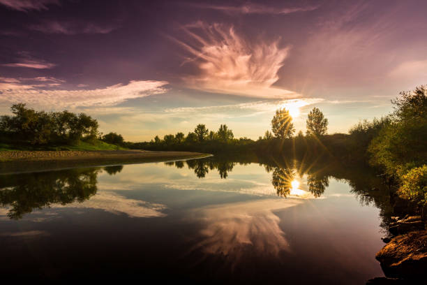 istock Scenery of wild river with sunset cloudy sky reflection 647545556
