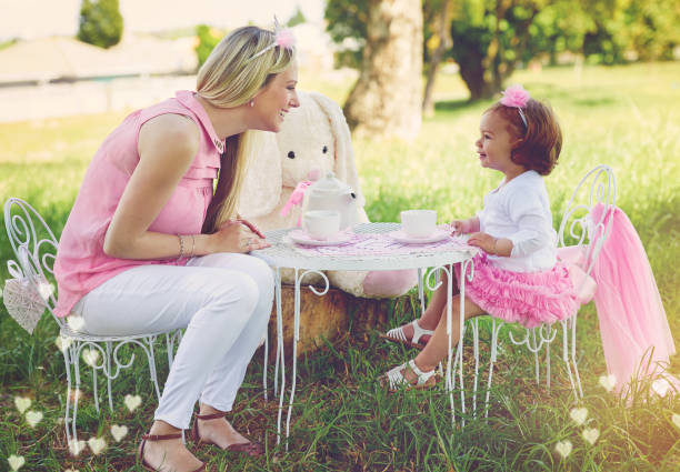 l'immaginazione è il loro giocattolo preferito - tea tea party afternoon tea women foto e immagini stock