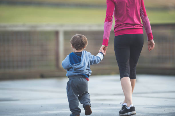 istock Young Hawaiian mom outside walking with two-year old son 647549376