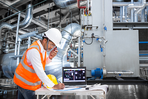 Electrical engineer working at control room of a modern thermal power plant