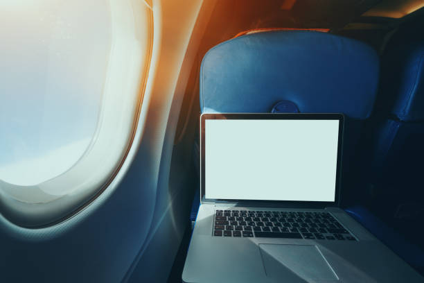 istock Laptop on the table of airplane seat 647559768