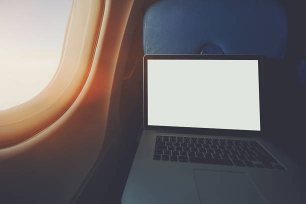 istock Laptop on the table of airplane seat 647559834