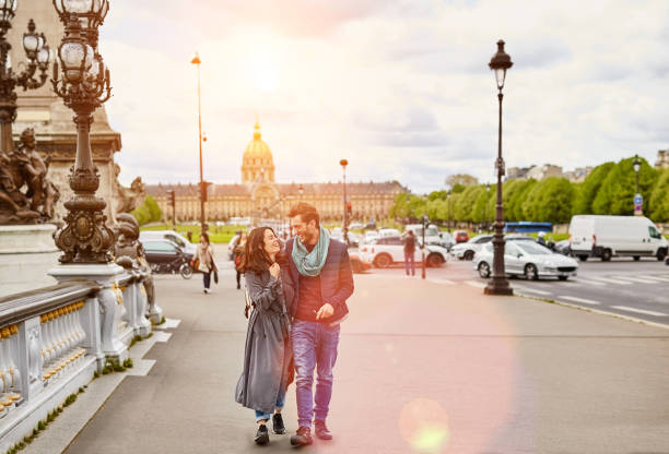 Enjoying a romantic day in the city Shot of a happy young couple enjoying a day together in Paris tourist couple candid travel stock pictures, royalty-free photos & images
