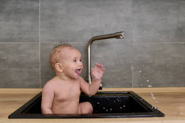 istock Funny baby in sink 647563942
