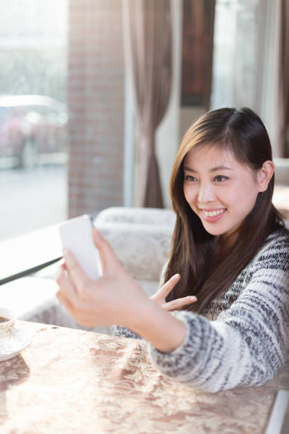 istock young pretty woman sits in cafe 647566224