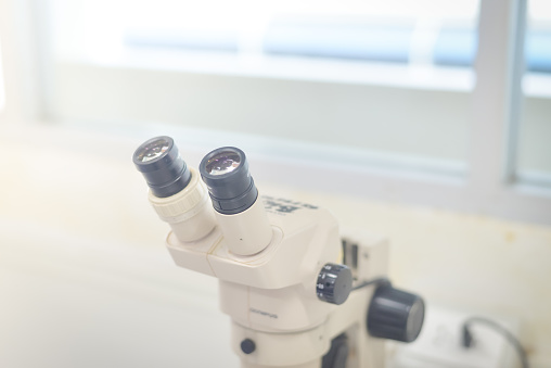 blurred sterio microscope in biology laboratory in white