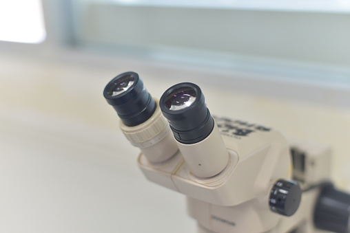 blurred sterio microscope in biology laboratory in white