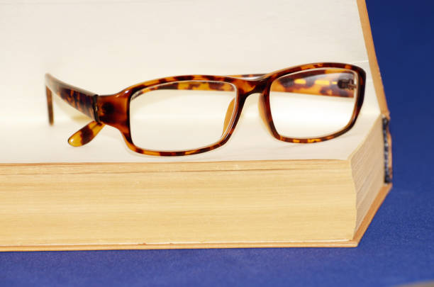 istock Glasses on the background of the book. 647566558