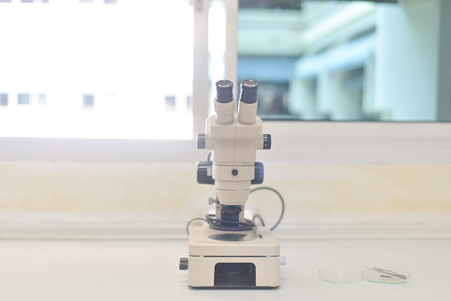 blurred sterio microscope in biology laboratory in white