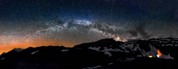 istock Camping in tent at night under Milky Way stars panorama 647567152