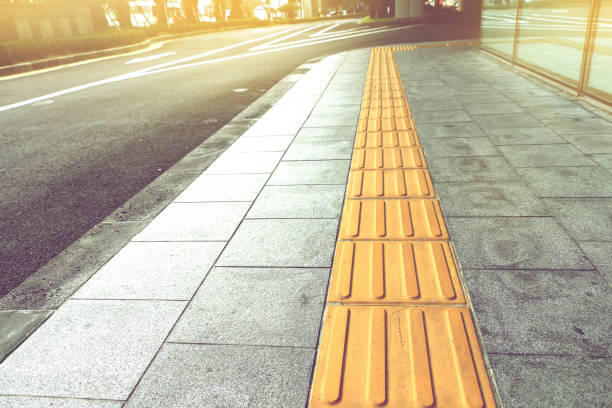 istock tactile paving for blind handicap on tiles pathway. 647567182