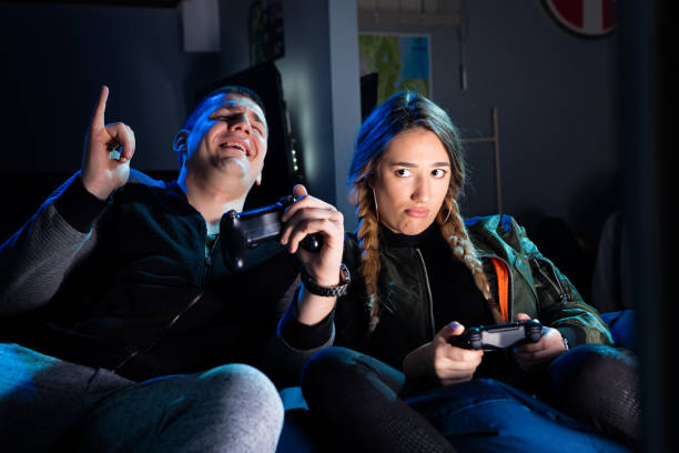 istock Happy couple playing video games and having fun together. 647570600