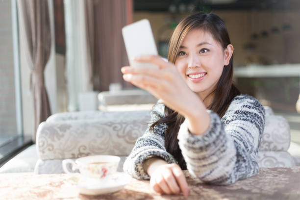 istock young pretty woman sits in cafe 647573088