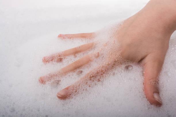 istock Child washing hands  in foam 647573582
