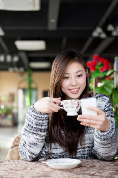 istock young pretty woman sits in cafe 647574632