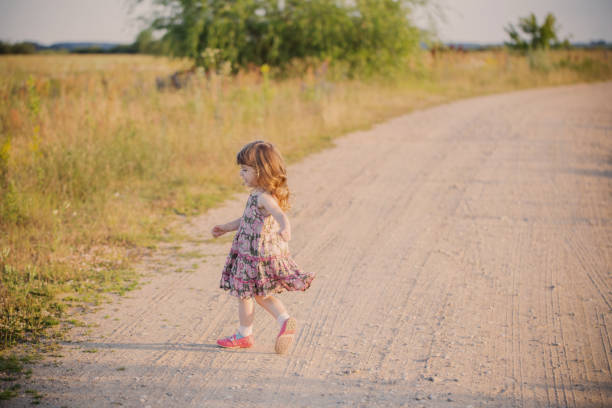 istock happy little girl on road 647577916
