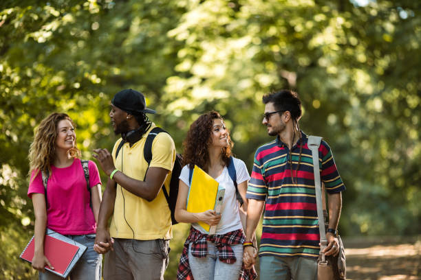 istock Two smiling couples in nature talking to each other. 647584760