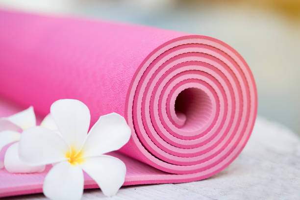 istock pink yoga mat and a flowers 647585602