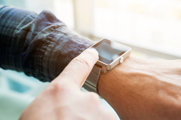 istock man connect smart watch with mobile phone 647588514
