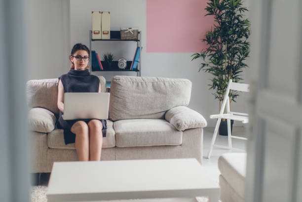 istock Happy woman using laptop at home 647606514