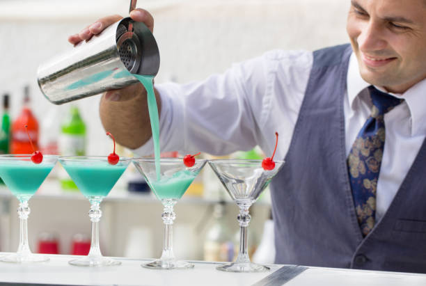 istock barman pouring a cocktail drink 647607344