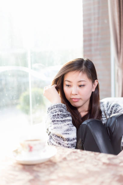 istock young pretty woman sits in cafe 647610406