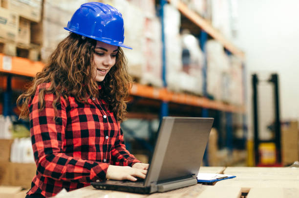 istock Businesswoman at warehouse checking inventory 647614674