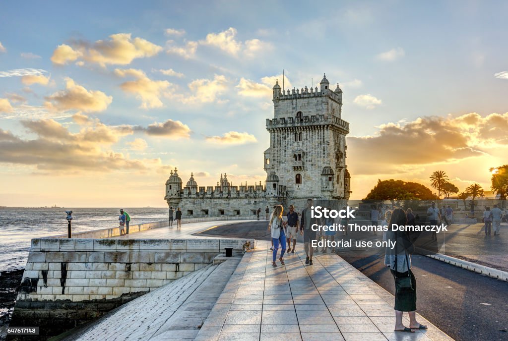 Tower of Belem Lisbon, Portugal - August 30,02016: Pedestrians at Torre de Belem at sunset. Lisbon - Portugal Stock Photo