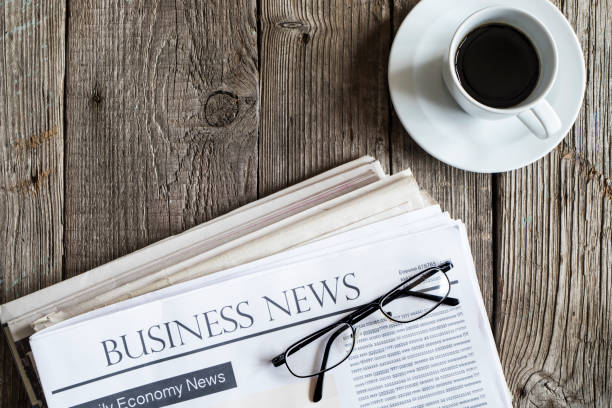 istock Newspaper on wooden table 647619550