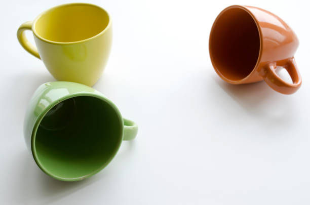 istock brightly yellow, orange and green ceramic cups 647622428