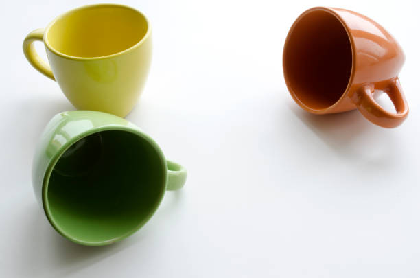 istock brightly yellow, orange and green ceramic cups 647622466