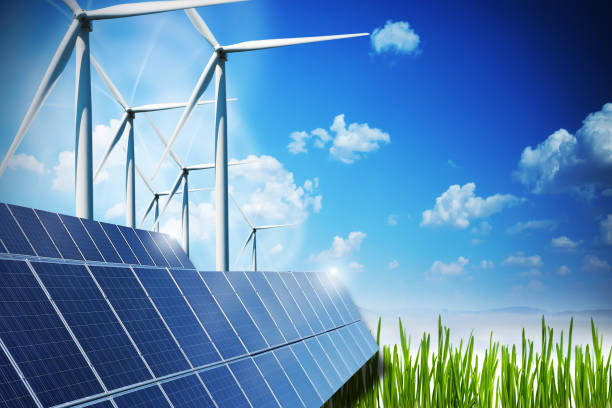 istock Renewable energy concept with solar panels and wind turbines on green field 647622714