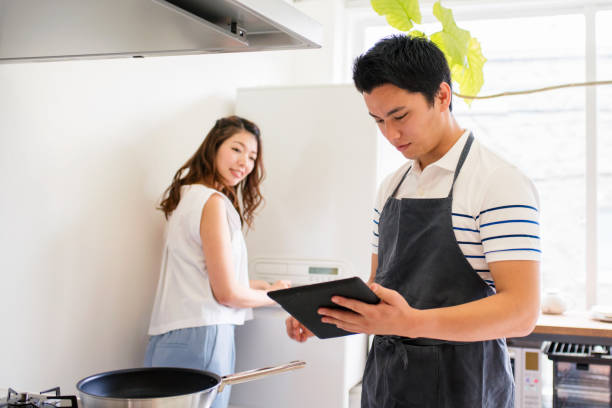 istock Young couple cooking together 647623314