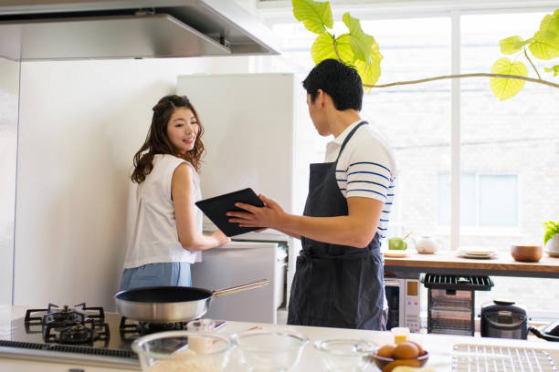 istock Young couple cooking together 647623332