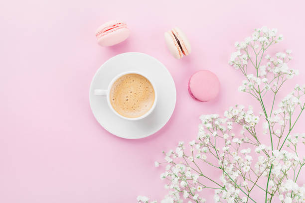 istock Morning cup of coffee, cake macaron and flowers. Flat lay. 647625676