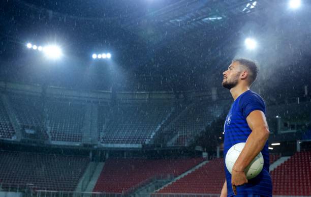 istock Football player standing in stadium 647629918